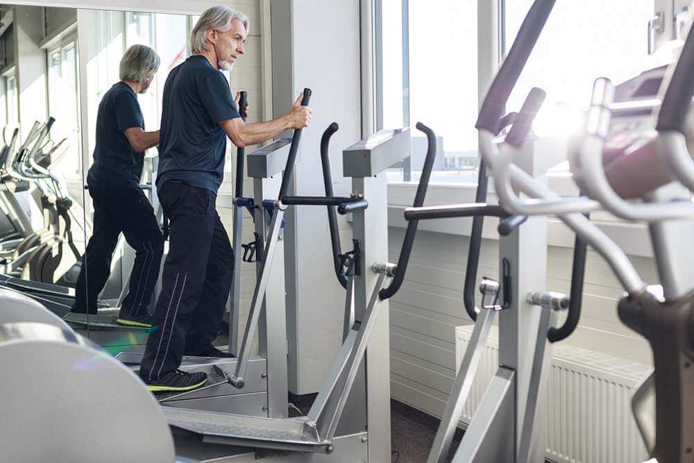 Senior man doing exercise in Gym