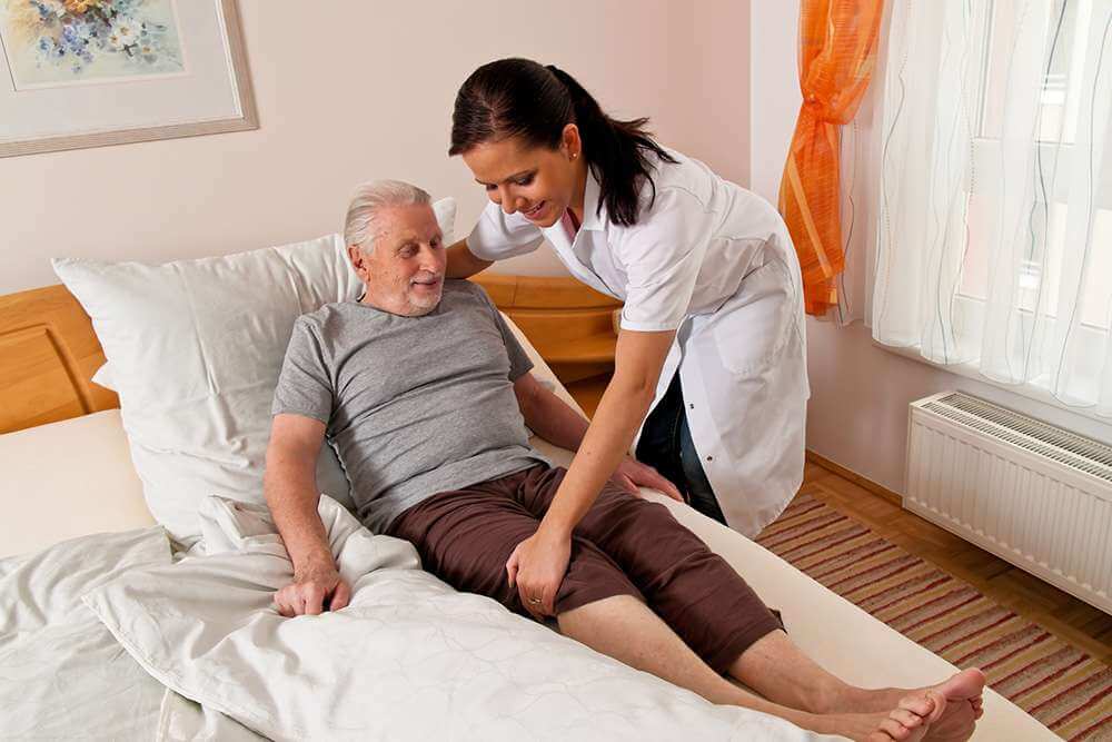 Physical therapist at home with patient
