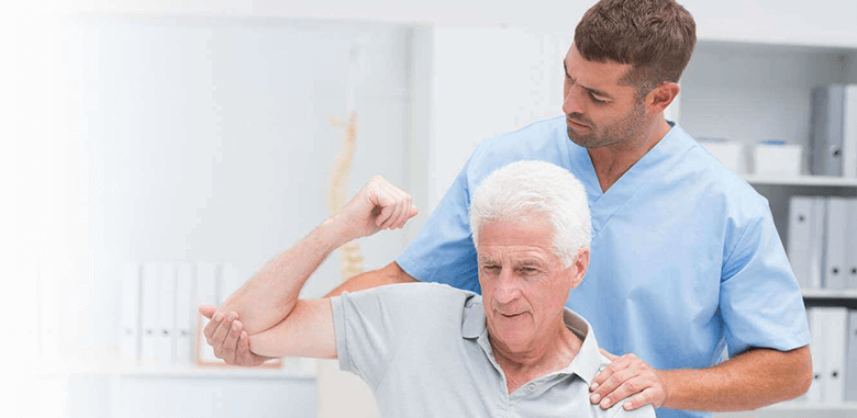 Therapist helping senior man in exercise