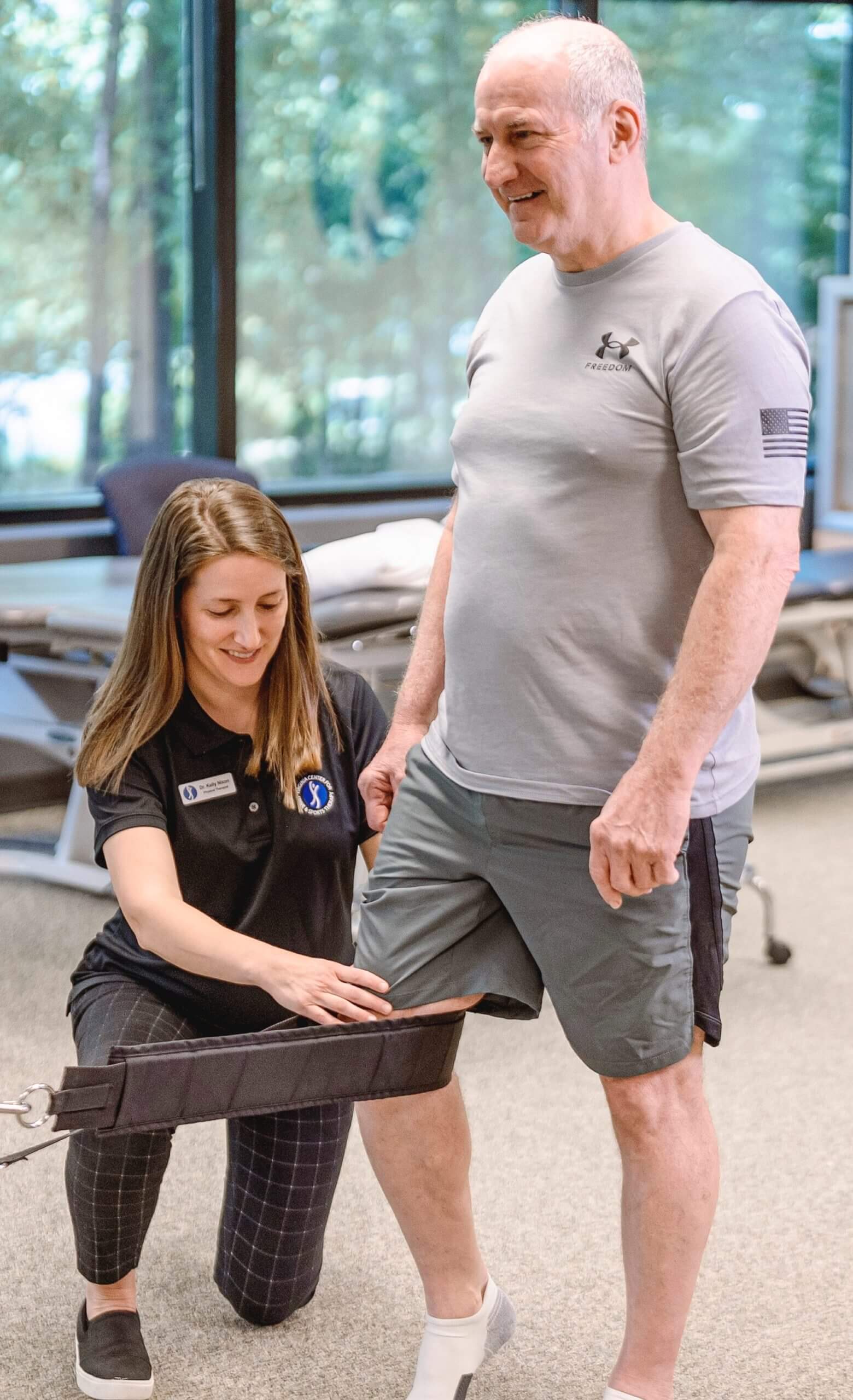 physical therapist treating patient's knee