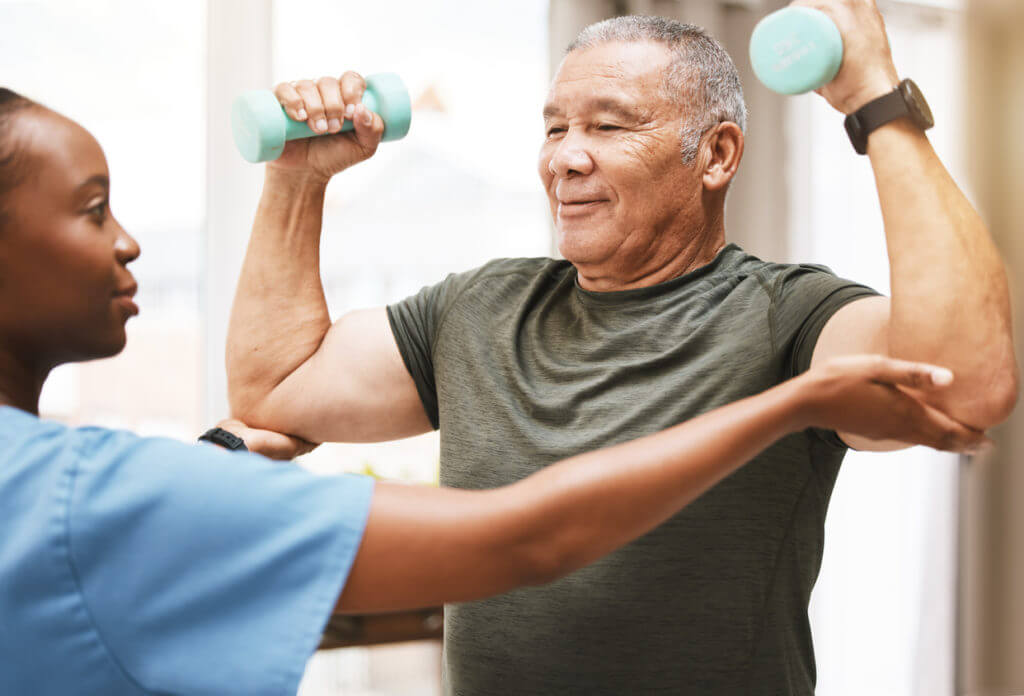 physical therapy with patient and black woman in nursing home