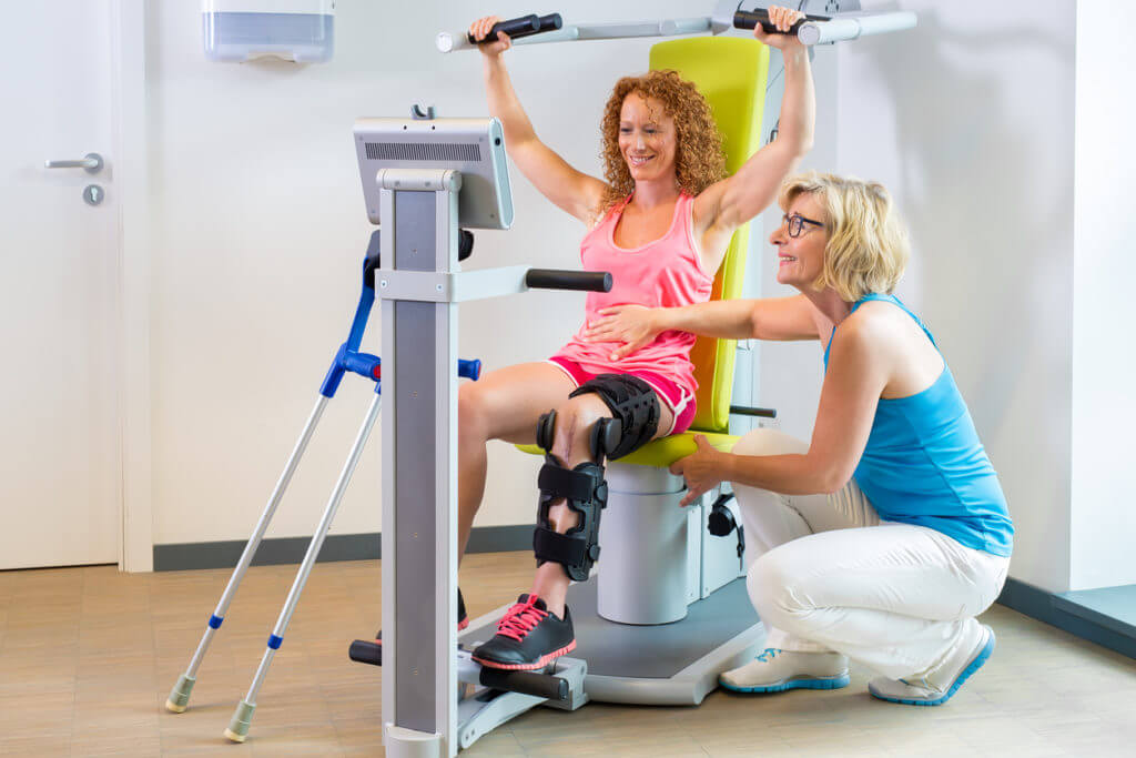 Patient getting help with leg rehabilitation