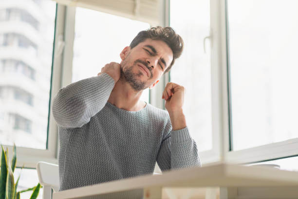 Young man having a neck pain in the morning.