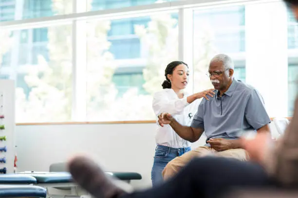 Physical therapist using scheduling software on tablet