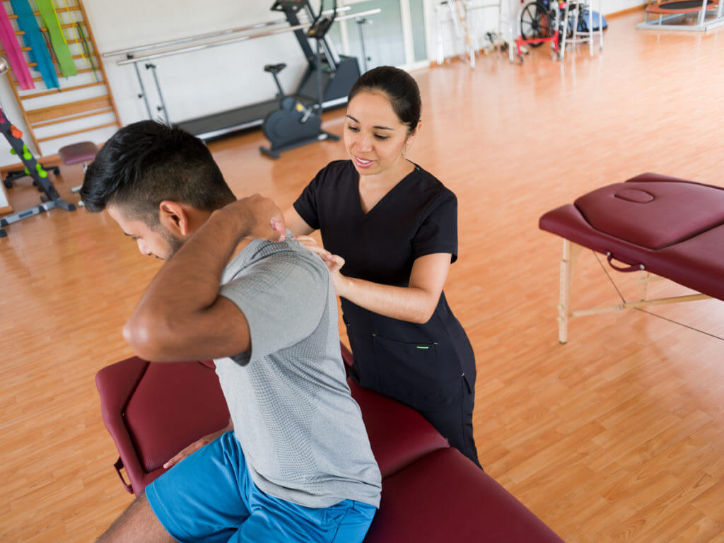 physical therapist treating patient's neck pain