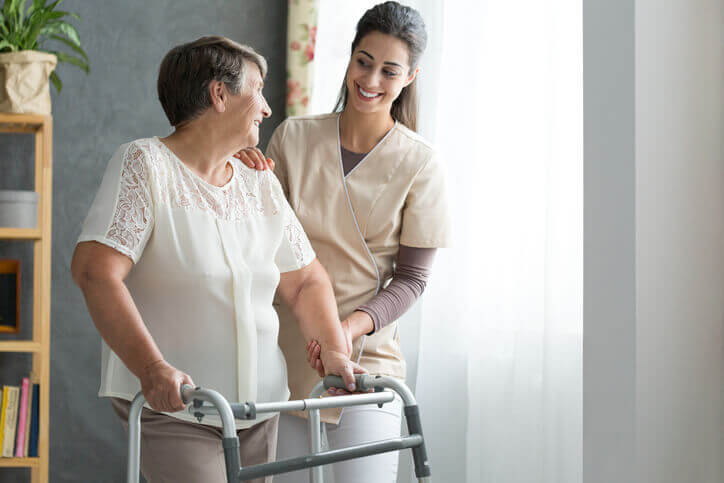 Physical Therapist Helping senior woman after hip surgery