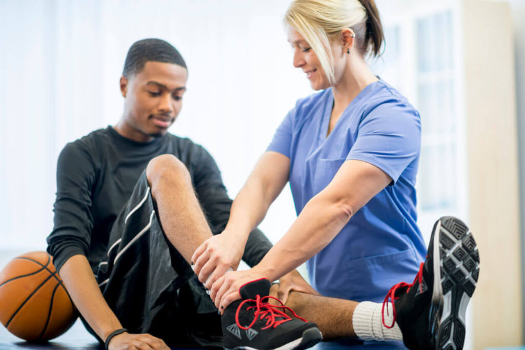 young male athlete getting physical rehabilitation