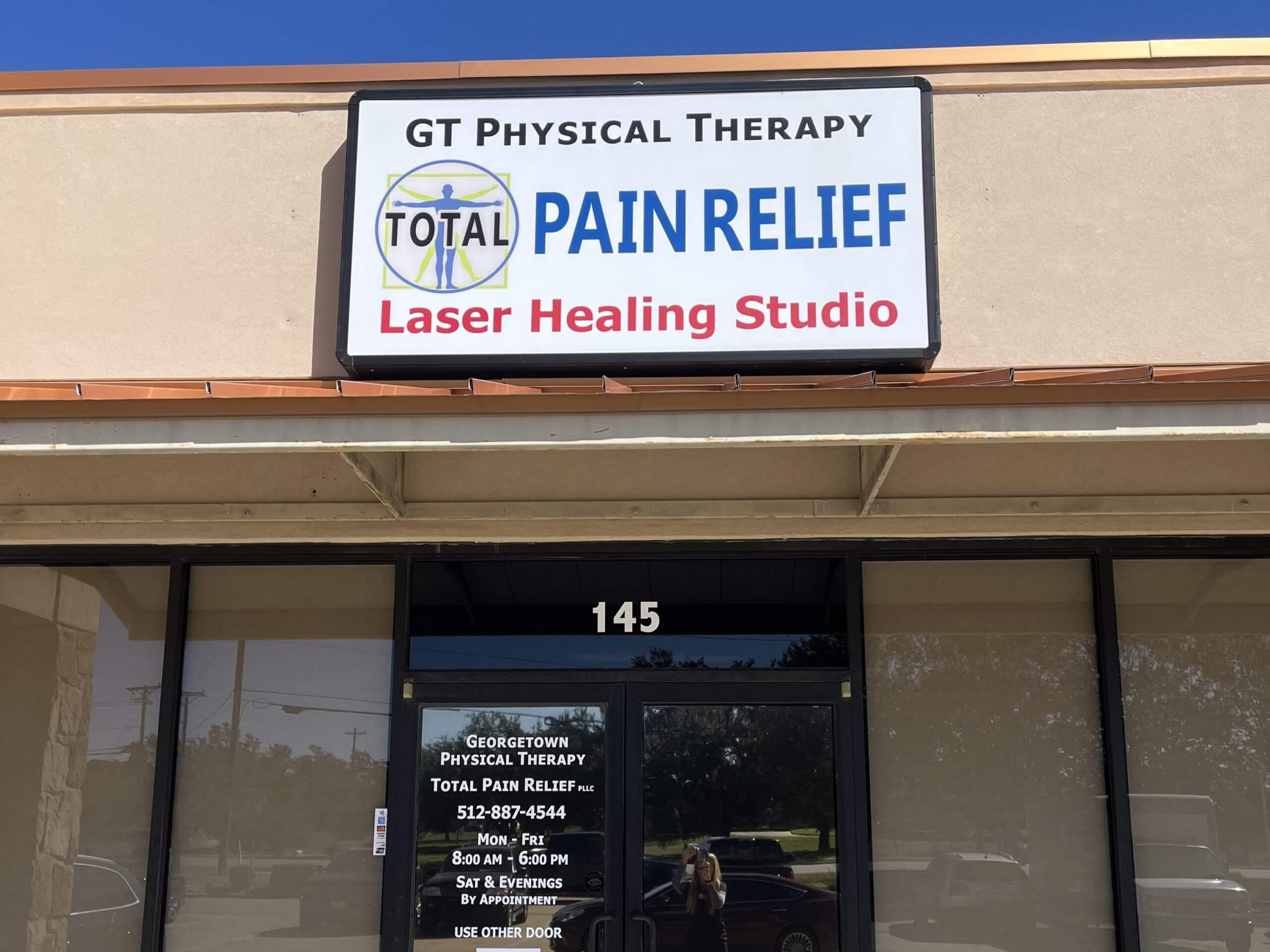 physical therapist exercising with patient and pointing to his foot