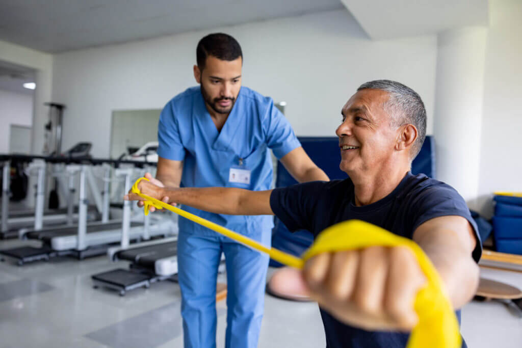 Man doing physical therapy exercises using a stretch band