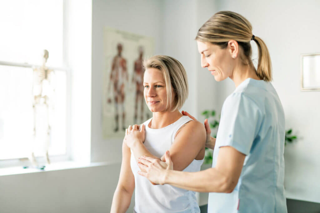 physical therapist working with woman