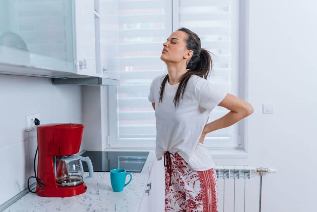 young woman dealing with low back pain