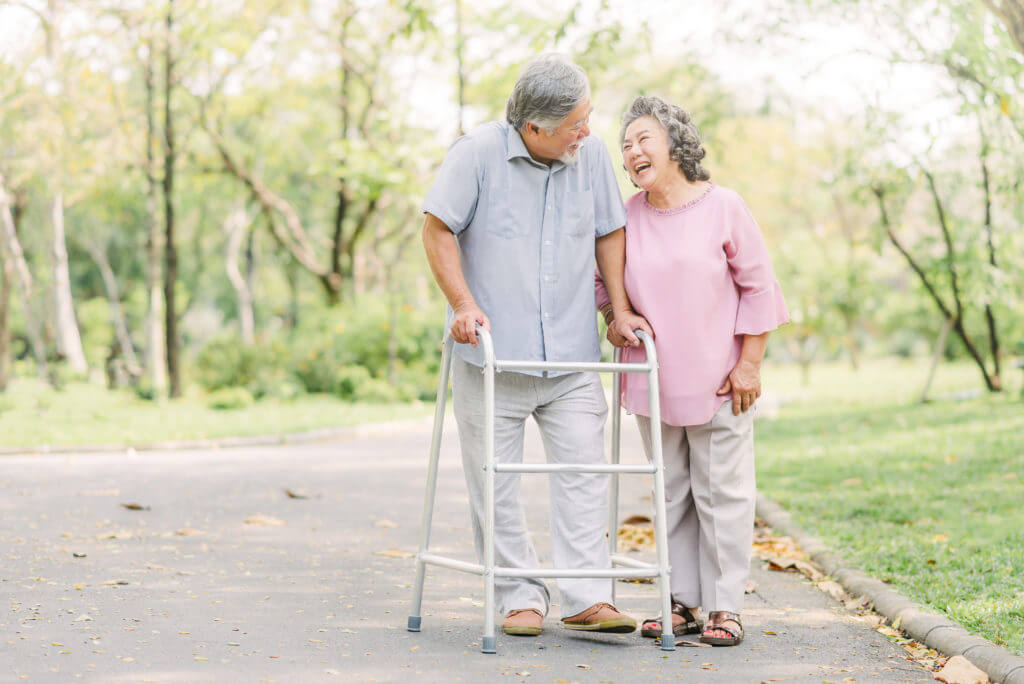 older couple walking with walker