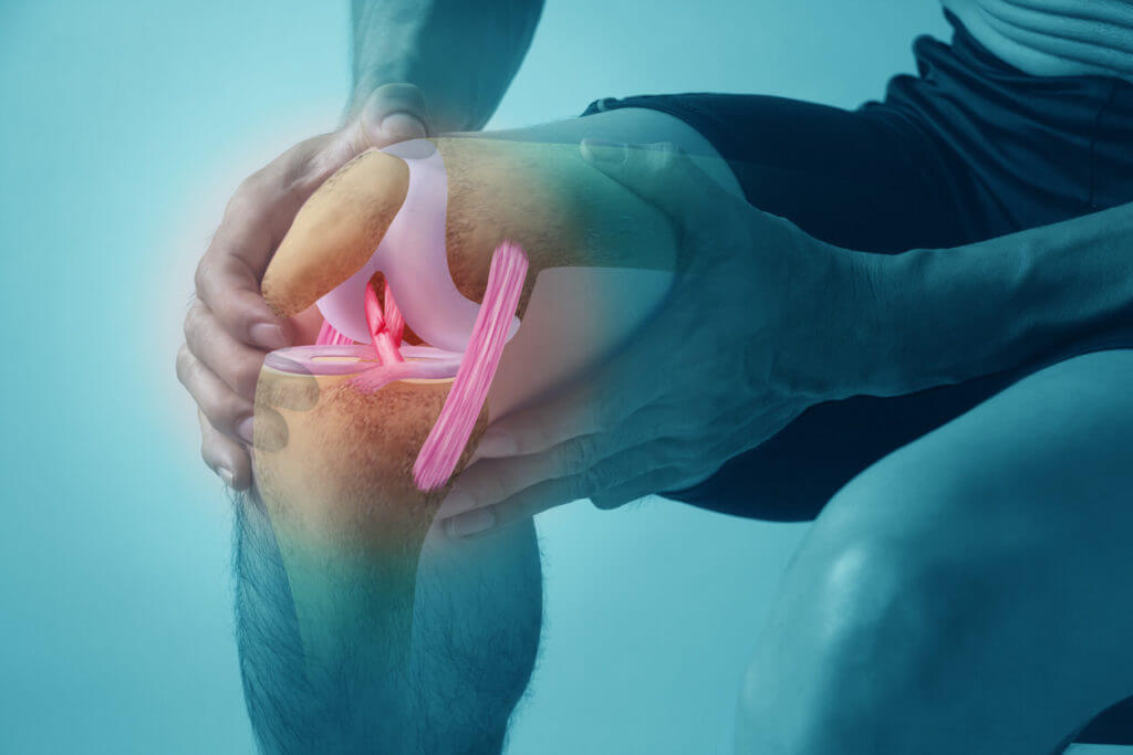 A man is holding his knee due to a serious injury.