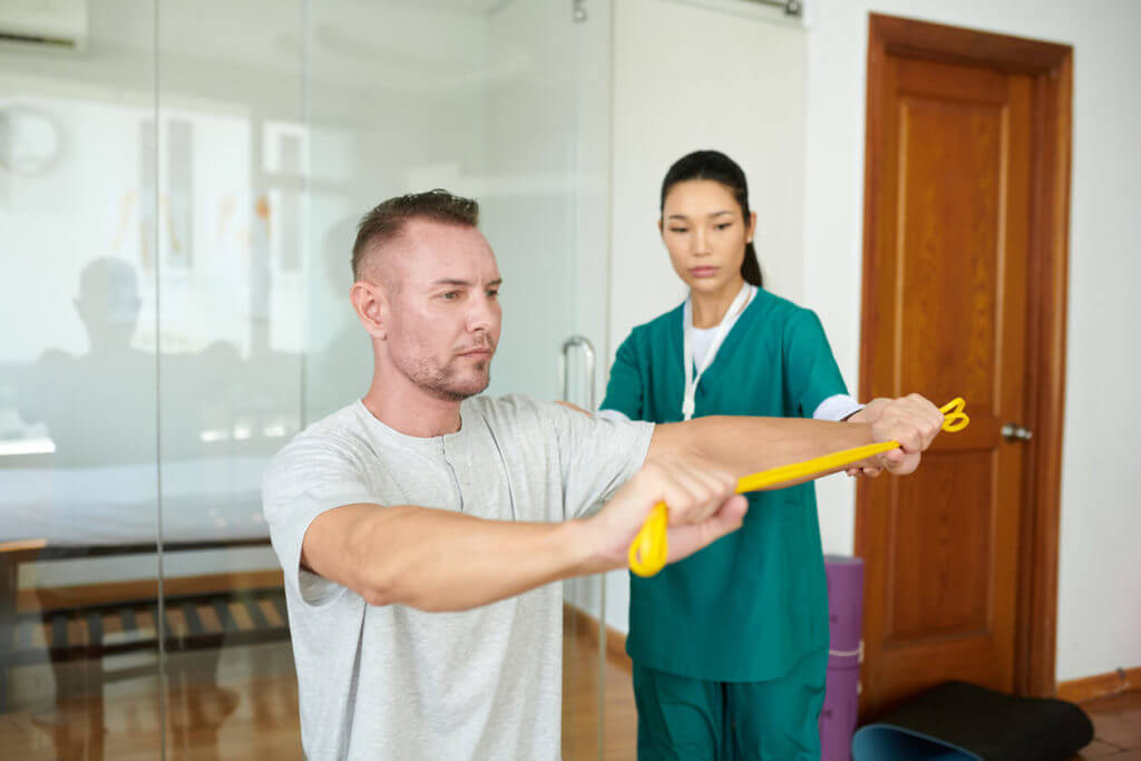 Man receiving physical therapy at a sports medicine center.