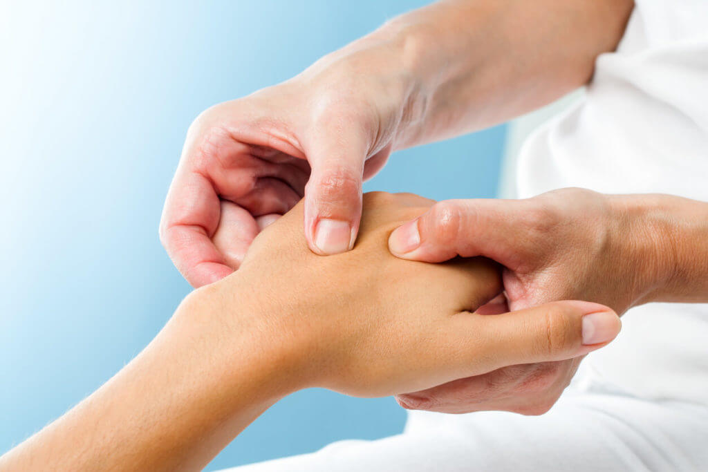 A hand specialist assessing a patient's hand.