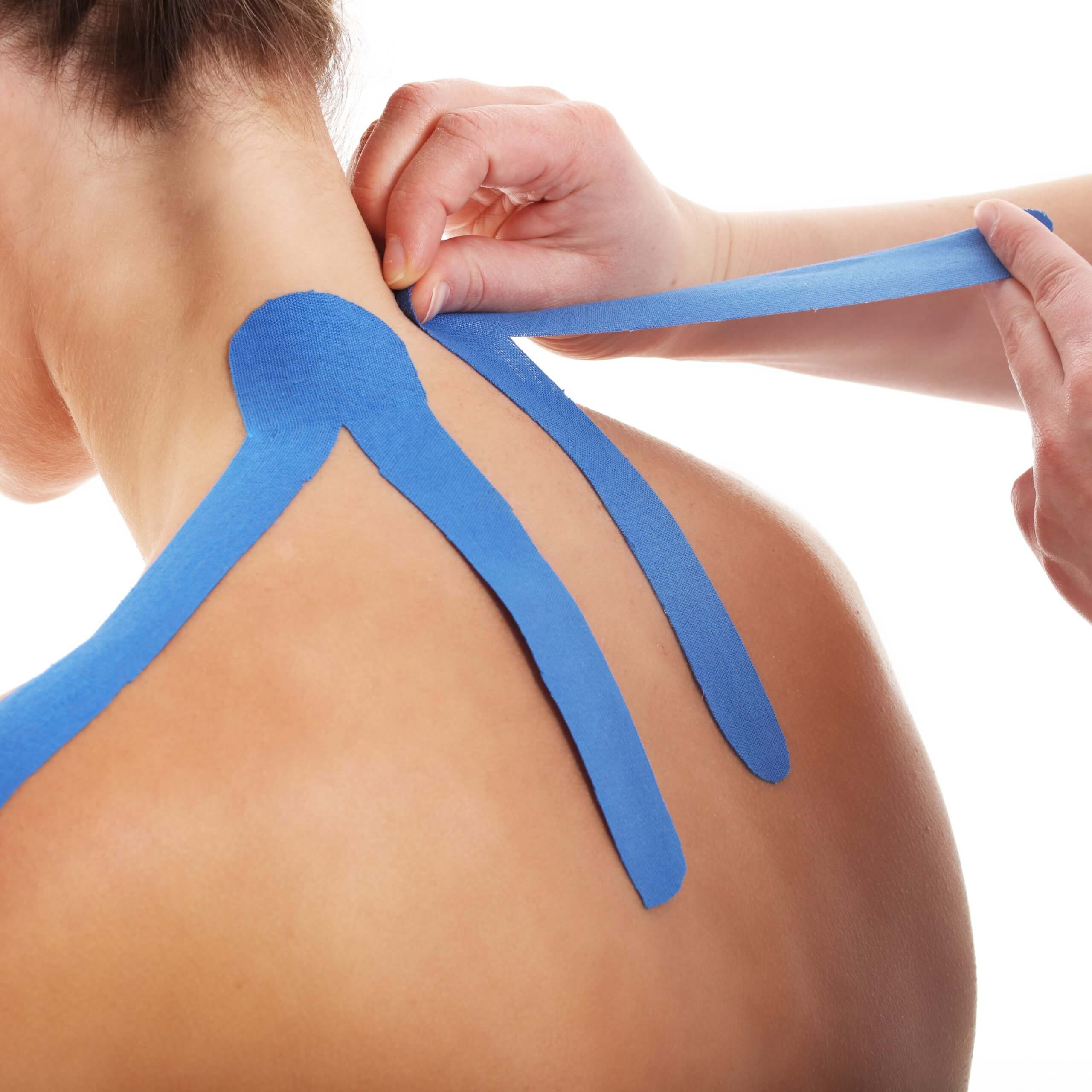 physical therapist completing kinesio taping to patient in schertz tx