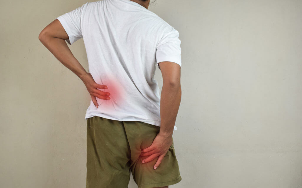 A patient with sciatica experiencing pain in their lower back and leg