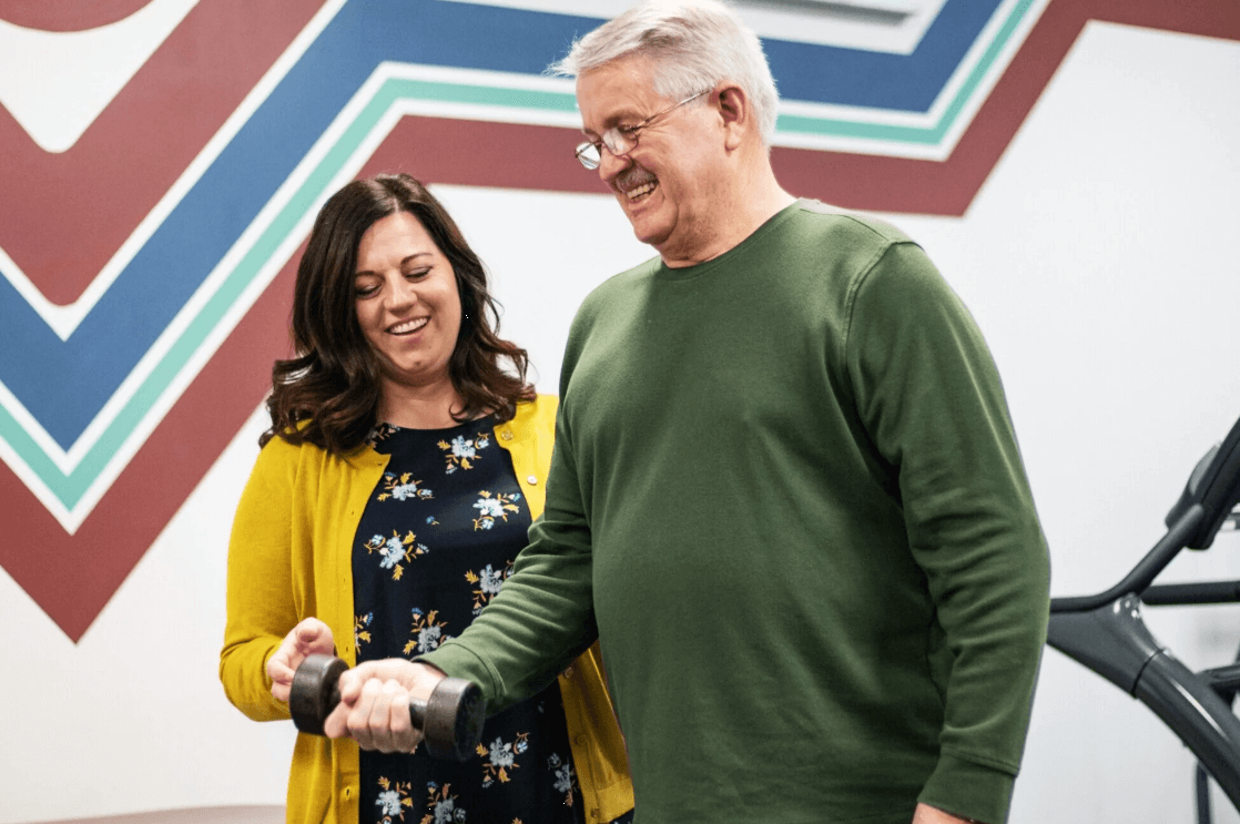 physical therapist working with patient on upper body strength